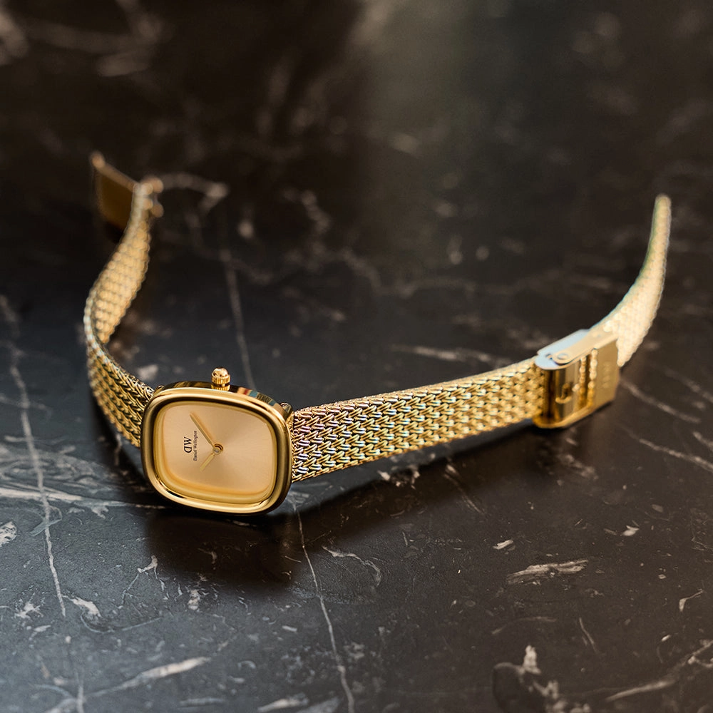 Margot collection watch worn on a wrist against a warm backdrop