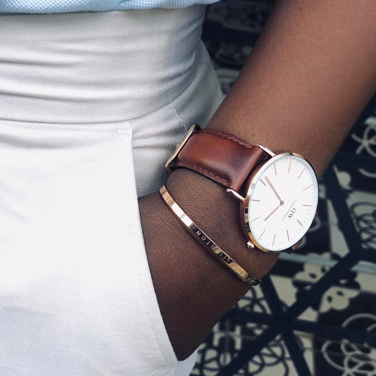 Rose gold watch with a white dial worn by a model